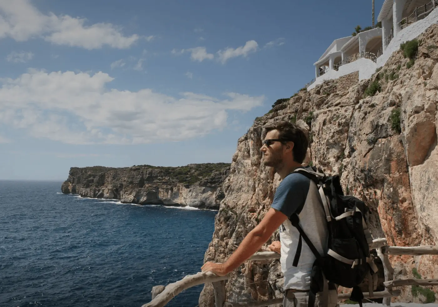 Barry looking out over the sea from a cliffside path on a bright day.